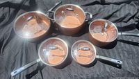 All five pots with lids in place