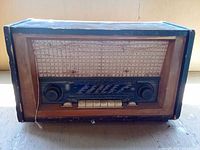 Front view of 1950s wood tube radio with fabric grille and glass dial