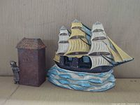 Overview of all three items: ship door stop, house block, child figure