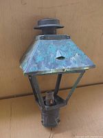 Front angled view showing overall lantern and patina