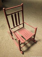 Full view of red child rocking chair angled