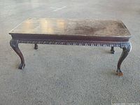 Full view of rectangular coffee table showing overall design and wear