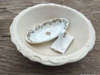 Top view of wash basin containing oval dish and soap holder