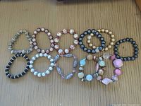 All thirteen bracelets laid out on surface