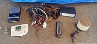 Group shot of cassette recorder, answering machine, cables, amplifier box, remote, cylindrical speaker