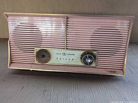 Front view showing twin speakers, grille, control panel