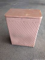 Closed pink wicker hamper front view