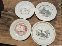 Four commemorative porcelain plates on table
