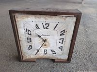 Front view showing wood case and paper dial