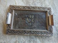 top view of tray showing carved border, glass inset, handles, overall wear