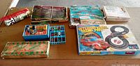Overall lot on table showing all boxed sets, Hess truck, diecast car trays