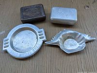 Group shot showing Stegmaier ashtray, Silver-Cid ashtray, and Parker tin lid and base