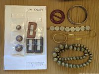 Entire lot showing necklaces, bracelets, bangle, buckle, buttons on card
