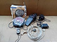 Group shot showing all items: hot plate with box, car vac, light meter, tape eraser, cords