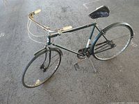 Full view of vintage green Hawthorne bicycle showing overall condition and components