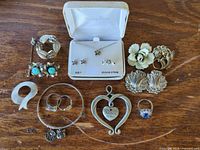 Overall view of jewelry lot laid out on wooden surface