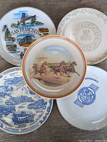 Group view of five decorative plates showing fronts
