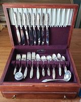 Chest open showing full flatware service