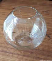 Full view of clear spherical cut glass bowl with etched floral design