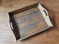 Top view of wooden tray showing interior and handles