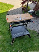 Full view of folded-out Workmate 400 workbench on grass