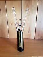 Full view of blown glass statuette on shelf