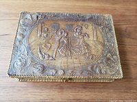 Top view showing carved flamenco dancer scene and floral border
