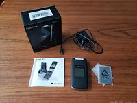 Lot overview showing phone, box, cable, manual, battery