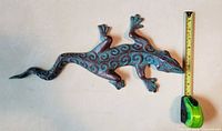 Top view of entire gecko beside tape for scale