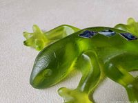 close-up of glass gecko head and shell inlays