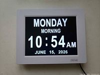 Clock powered on displaying Monday morning 10:54 AM June 15 2026