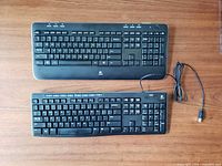 Front view of both keyboards showing layouts and wired connection
