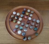 Top view of complete solitaire board showing all stone marbles in place