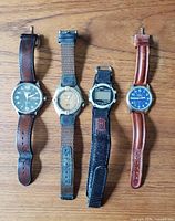 Group shot of all four watches laid out side-by-side