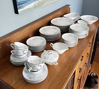 Full view of stacked Noritake Arlene china pieces on sideboard