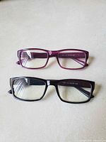 Two unbagged reading glasses purple and black gradient