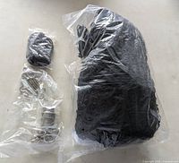 Packaged black nylon net and bagged mounting hardware