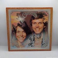 Front sleeve in protective frame showing artist photo and title