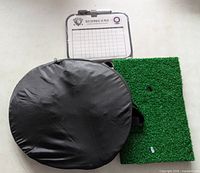 Carrying case, artificial turf mat, scorecard clipboard visible