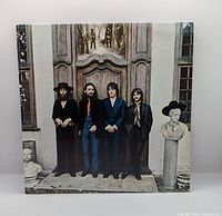 Front of picture sleeve showing Beatles standing in doorway