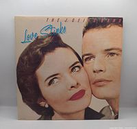 Front cover of Love Stinks LP