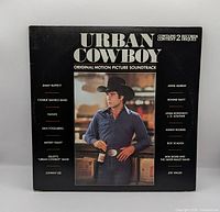 Front cover showing title, image of John Travolta, contains 2 records note