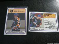 Fronts of both cards in sleeves: OPC Record Breaker and Topps Team Leaders