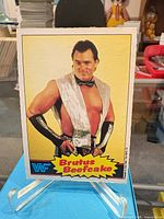 Front of WWF Brutus Beefcake trading card on stand