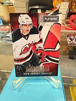 Front of Jaromir Jagr 2013-14 Panini Playbook card showing image, Devils logo, serial number 118/249