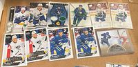 Group shot of all Brock Boeser cards including Parkhurst bases, All-Star inserts, Artifacts patch and UD Canvas