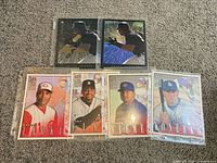 All five cards in protective sleeves