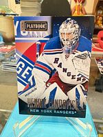 Front view of Henrik Lundqvist Panini Playbook card on stand