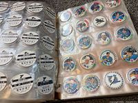 open binder showing colour NHL player POGs in capsules and reverse black-and-white stat sides