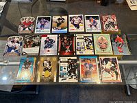 Full lot overview showing both rows of hockey cards on glass table